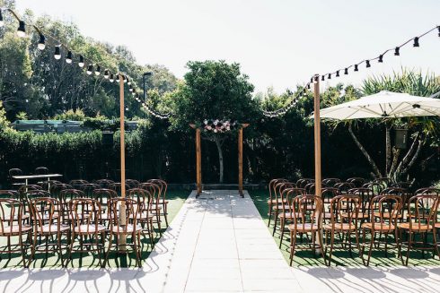 private garden wedding ceremony with wooden arbour