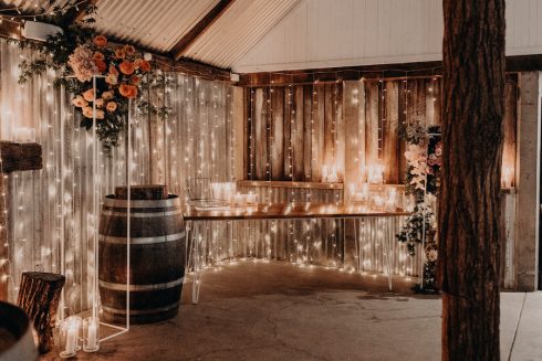 Beautiful twinkling fairy lights cover the wall of the barn at The Acre