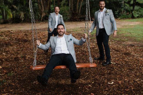 A groom on the tree swing at the acre, one of the key photo locations
