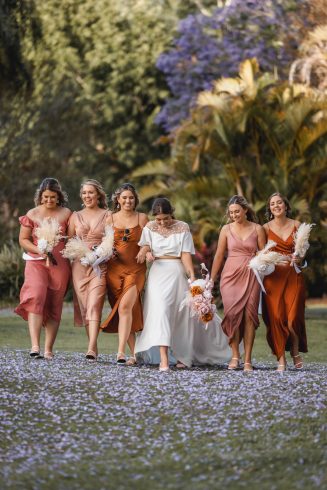 MODERN BRIDE AND HER BRIDESMAID WITH JACARANDA BLOOMING TREE