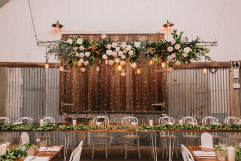 Floral hanging install in wedding barn