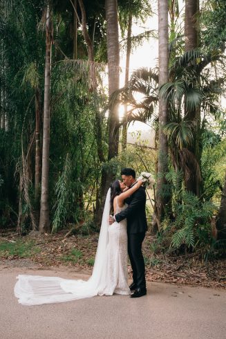 Bride + groom kissing in garden