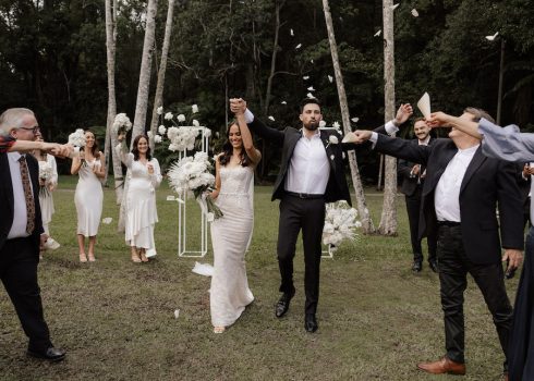 Bride + groom showered with confetti