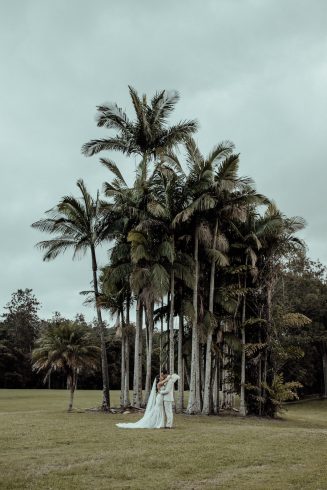 Bride + groom under palm trees