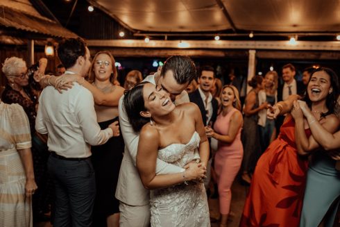 Bride + groom kissing on dance floor